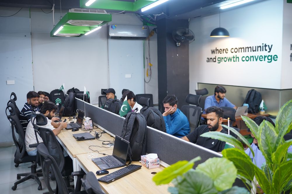Startup founders collaborating at the WorkX community wall in Lahore